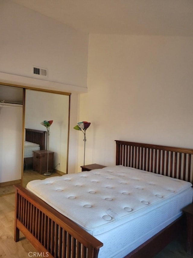 unfurnished bedroom featuring hardwood / wood-style floors and a closet