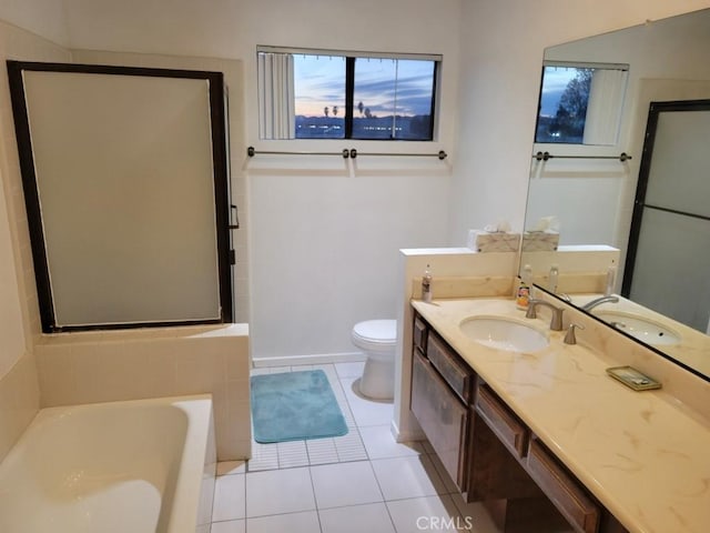 bathroom with tile patterned flooring, vanity, toilet, and a bathing tub