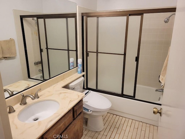 full bathroom with vanity, combined bath / shower with glass door, and toilet