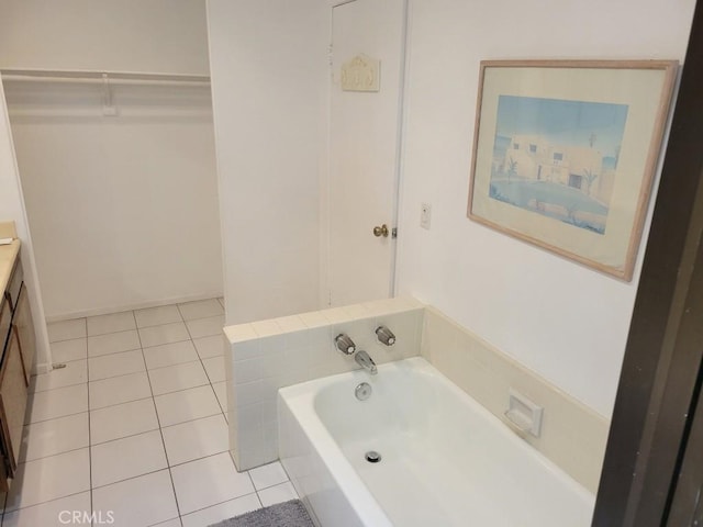 bathroom with vanity, tile patterned floors, and a tub