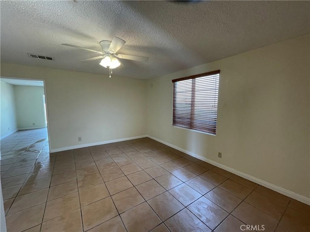 unfurnished room featuring ceiling fan, a textured ceiling, and light tile patterned flooring