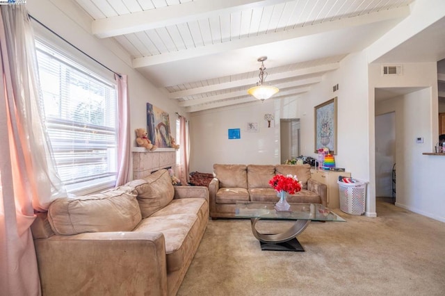 carpeted living room with lofted ceiling with beams