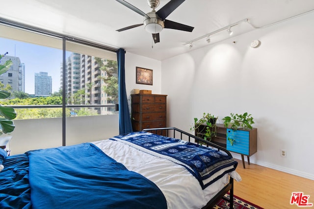 bedroom featuring ceiling fan and wood-type flooring