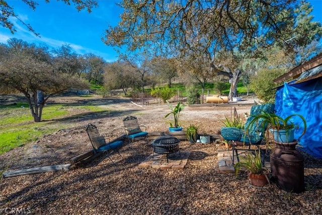 view of yard featuring a fire pit