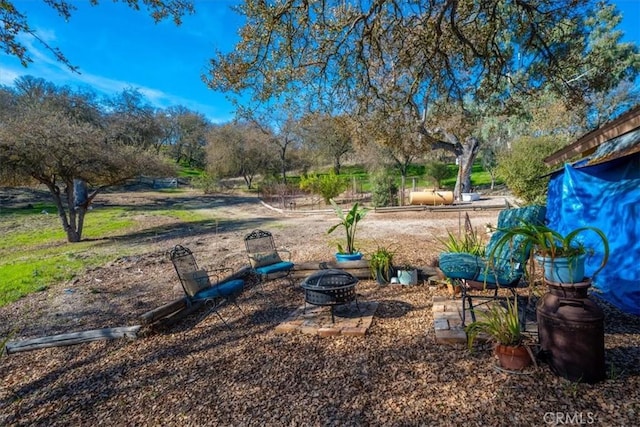view of yard featuring a fire pit