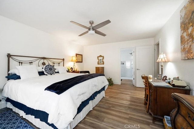 bedroom featuring dark hardwood / wood-style flooring and ceiling fan