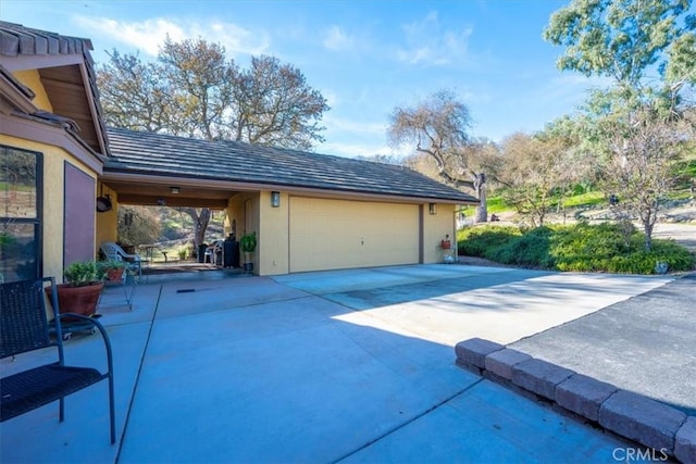 garage featuring concrete driveway