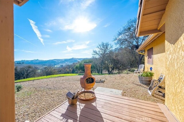 wooden deck featuring a mountain view