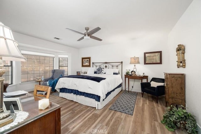 bedroom with wood-type flooring and ceiling fan