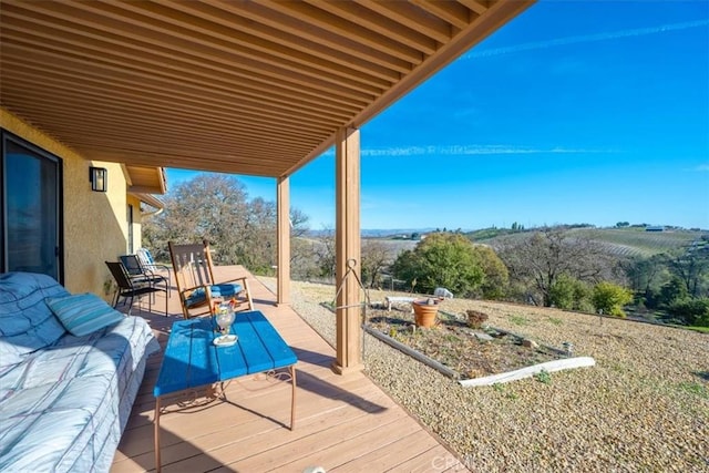 wooden terrace featuring an outdoor hangout area