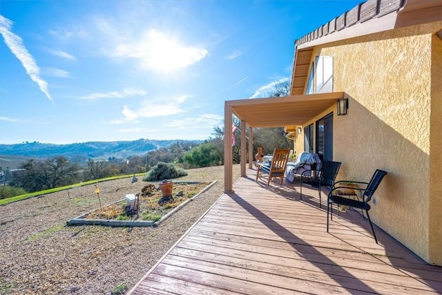 wooden deck with a mountain view