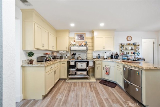 kitchen with backsplash, light hardwood / wood-style flooring, light stone countertops, and kitchen peninsula