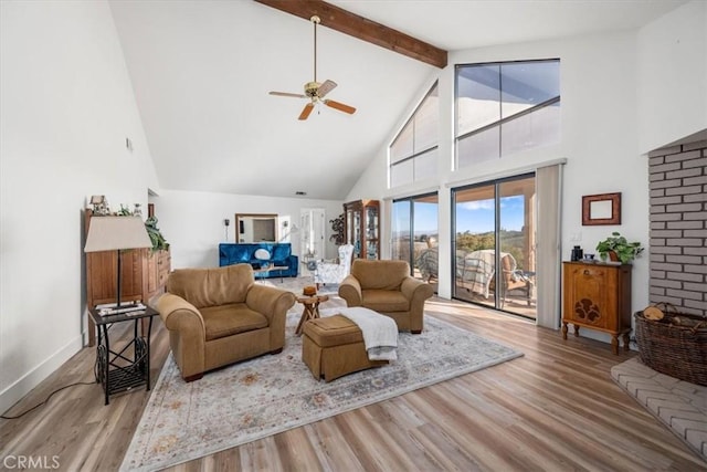 living area with high vaulted ceiling, wood finished floors, a ceiling fan, and beam ceiling