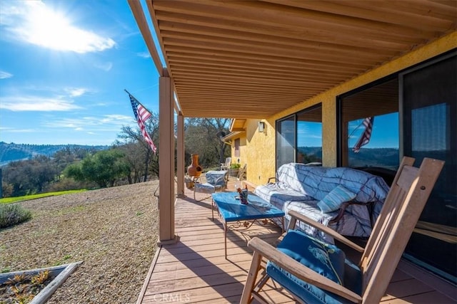 wooden terrace featuring an outdoor hangout area