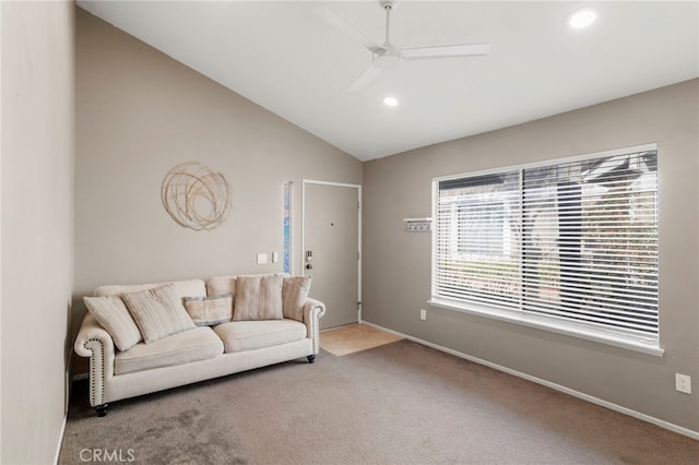 carpeted living room with ceiling fan and lofted ceiling