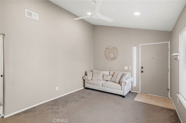 interior space with lofted ceiling, ceiling fan, and carpet floors