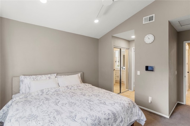 bedroom with ceiling fan, lofted ceiling, a closet, and carpet floors