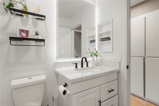 bathroom featuring toilet and vanity