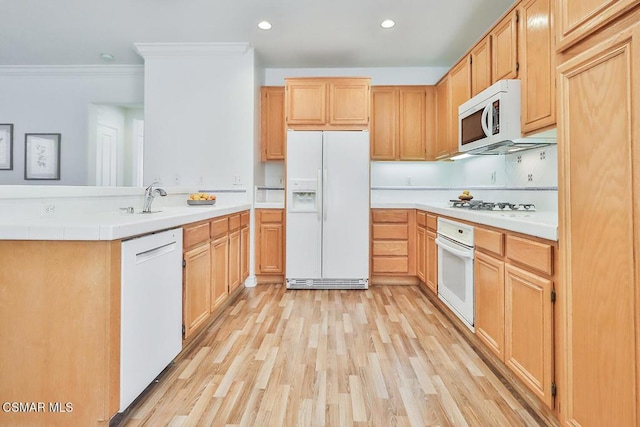 kitchen featuring light hardwood / wood-style floors, sink, crown molding, white appliances, and light brown cabinetry