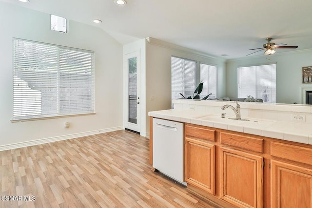 kitchen with dishwasher, a healthy amount of sunlight, sink, tile countertops, and ceiling fan