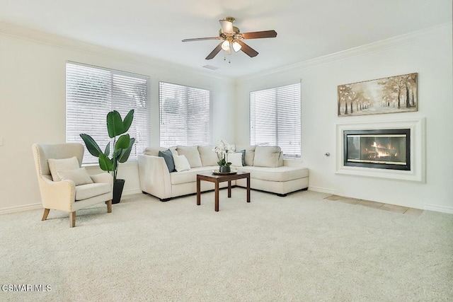 carpeted living room featuring ceiling fan and crown molding