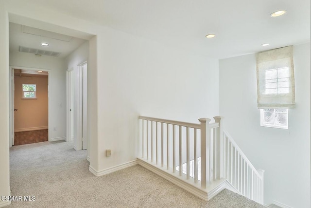 corridor featuring light colored carpet