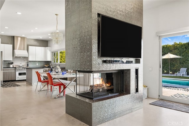 living room featuring an inviting chandelier and a multi sided fireplace