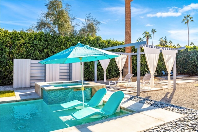 view of swimming pool with an in ground hot tub, a storage shed, and a patio