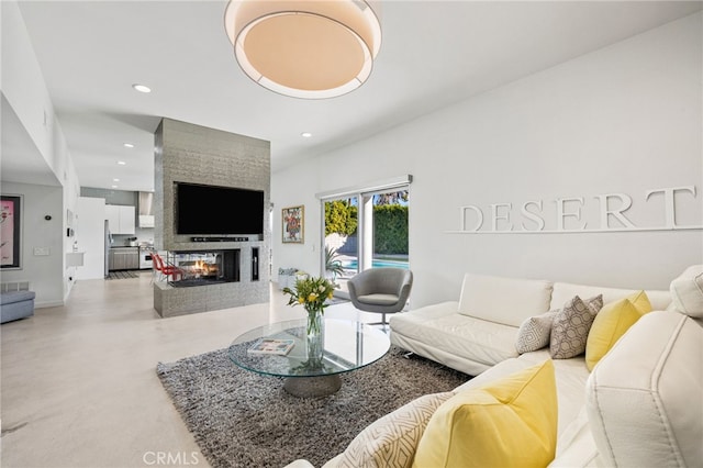 living room with concrete flooring and a multi sided fireplace