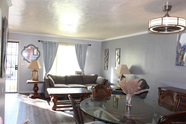 living room with hardwood / wood-style flooring and ornamental molding