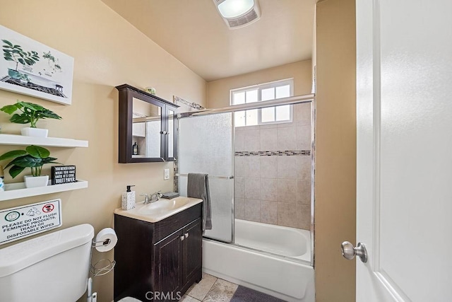 full bathroom with tile patterned floors, shower / bath combination with glass door, vanity, and toilet