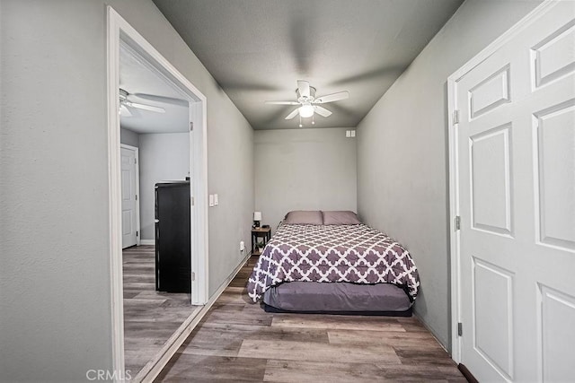 bedroom featuring ceiling fan and light wood-type flooring