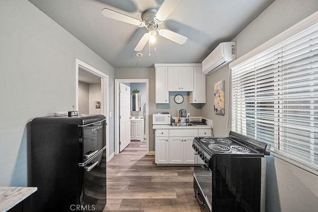 kitchen featuring white cabinetry, a wall unit AC, ceiling fan, dark hardwood / wood-style flooring, and black electric range oven