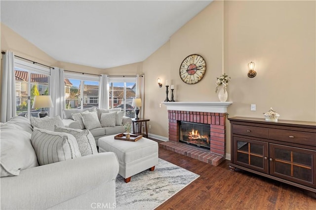 living room with a brick fireplace, plenty of natural light, dark hardwood / wood-style flooring, and lofted ceiling