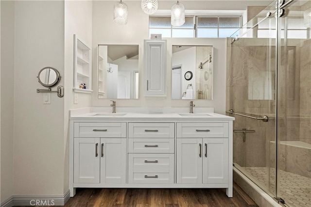 bathroom with an enclosed shower, vanity, and hardwood / wood-style flooring