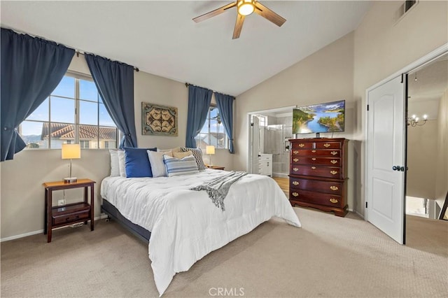 bedroom with ceiling fan, lofted ceiling, connected bathroom, and light colored carpet