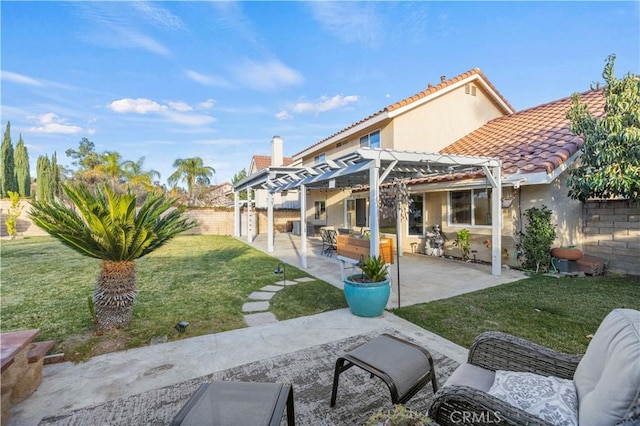 back of house with a pergola, a patio area, and a yard