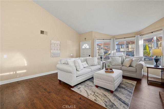 living room featuring high vaulted ceiling and dark hardwood / wood-style flooring