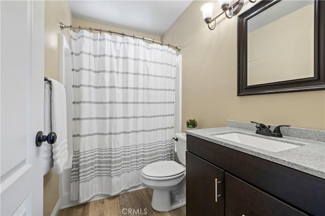 full bathroom featuring toilet, wood-type flooring, vanity, and shower / tub combo with curtain