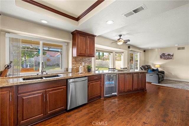 kitchen with wine cooler, dishwasher, sink, a tray ceiling, and ornamental molding