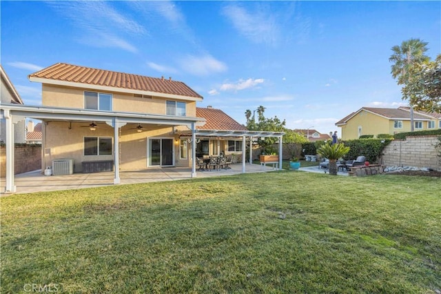 rear view of house featuring a patio area, cooling unit, a lawn, and a pergola