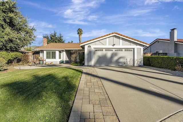 view of front facade featuring a front lawn and a garage