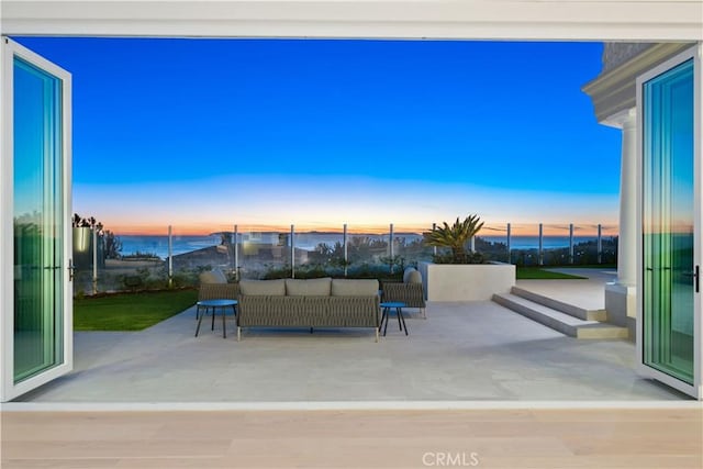 patio terrace at dusk featuring an outdoor hangout area