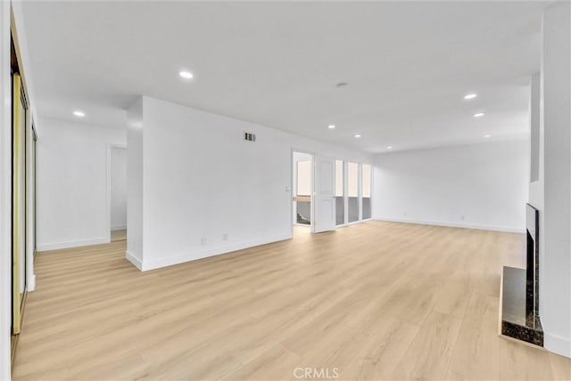 unfurnished living room featuring light hardwood / wood-style floors