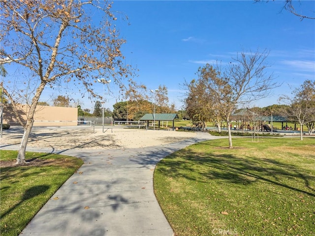 view of community featuring volleyball court and a lawn