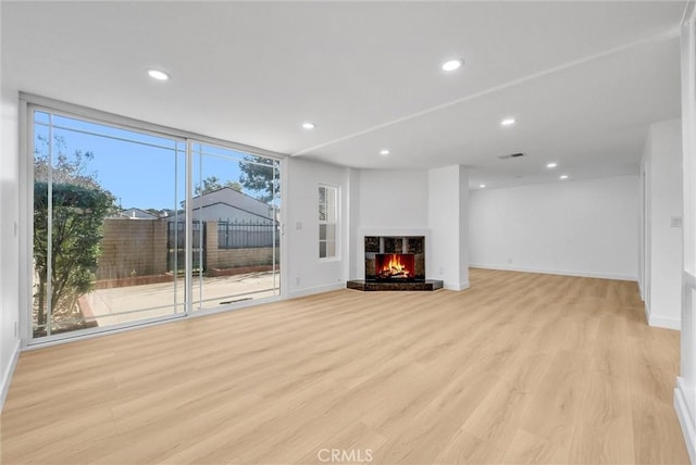 unfurnished living room featuring light hardwood / wood-style floors and expansive windows