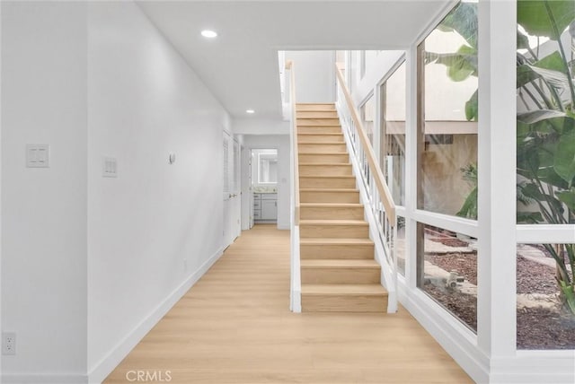 hallway with light hardwood / wood-style flooring