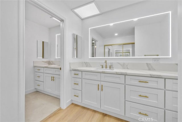 bathroom with hardwood / wood-style floors and vanity