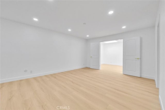 unfurnished room with light wood-type flooring