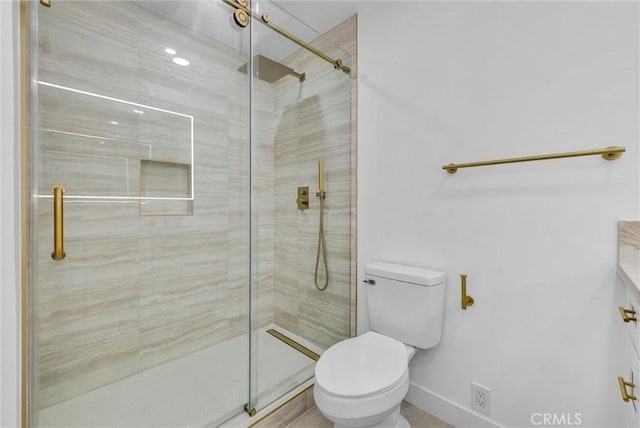 bathroom with toilet and a shower with door